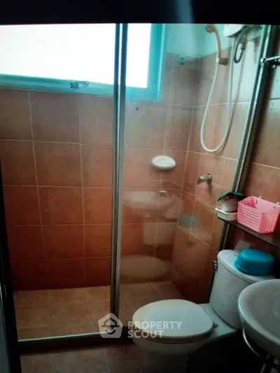 Compact bathroom with shower and toilet in cozy apartment