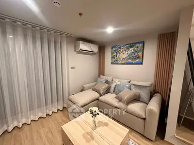 Cozy living room with modern decor and comfortable seating, perfect for relaxation.