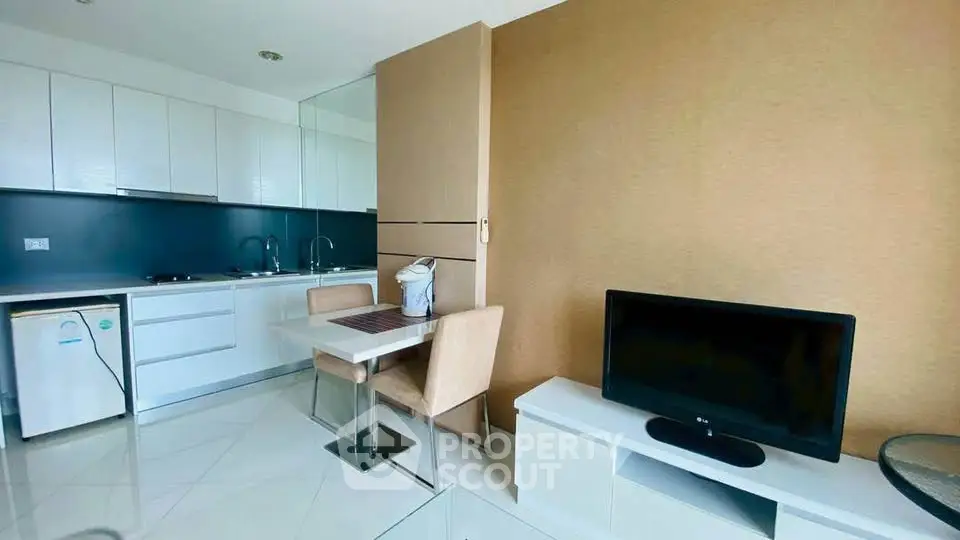 Modern kitchen and dining area with sleek design and compact layout.