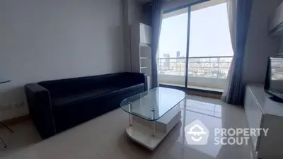 Modern living room with glass coffee table and city view balcony