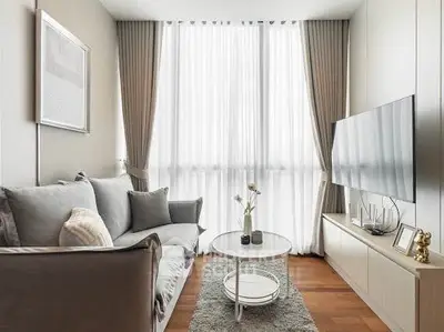 Modern living room with elegant decor, large window, and cozy seating area.