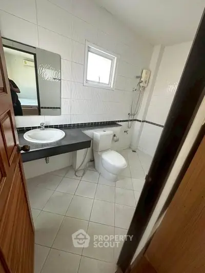 Modern bathroom with sleek fixtures and white tile design