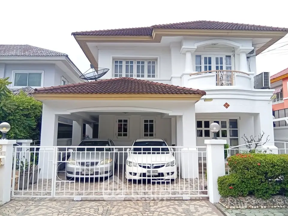 Elegant two-story house with spacious driveway and modern design in a serene neighborhood.