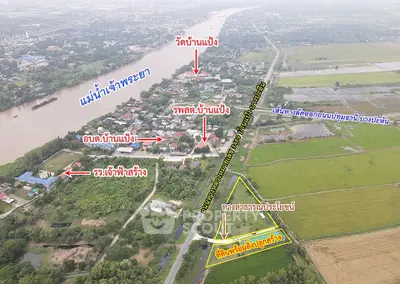 Aerial view of land plot near Mae Phra Ya River with surrounding landmarks.