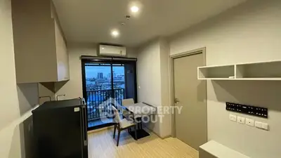 Modern compact apartment with balcony and city view, featuring sleek kitchen and dining area.