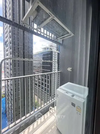 High-rise apartment balcony with washing machine and city view