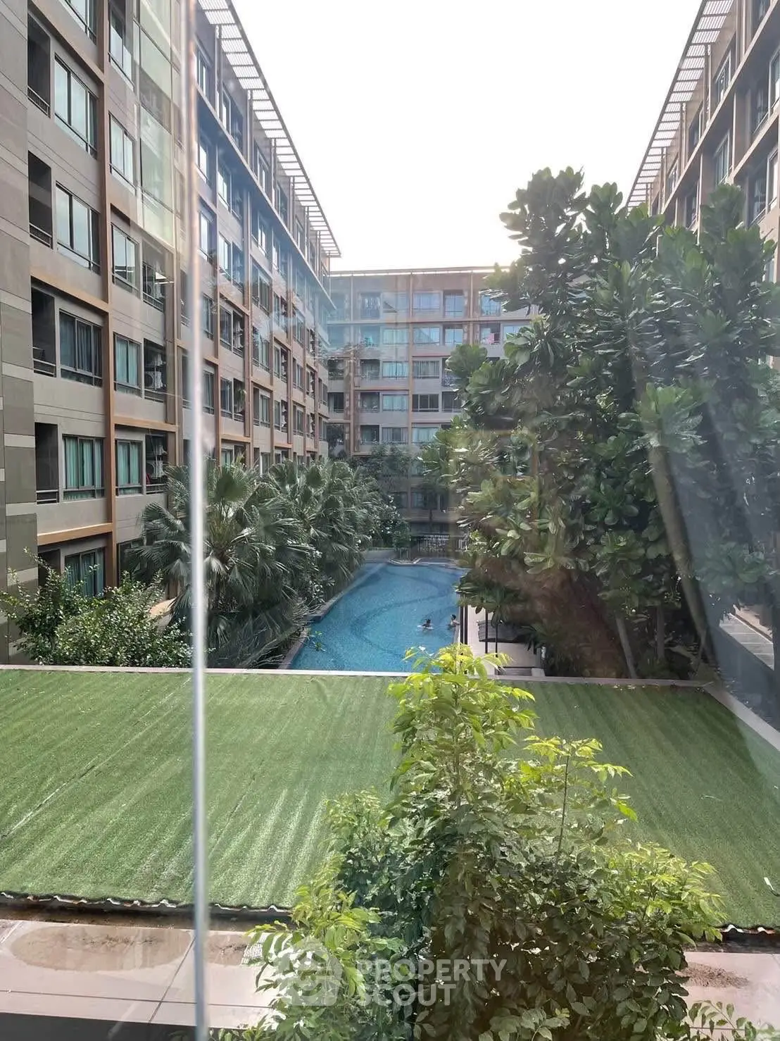 Luxurious residential complex with stunning pool view and lush greenery