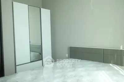 Modern bedroom with sleek wardrobe and comfortable bed