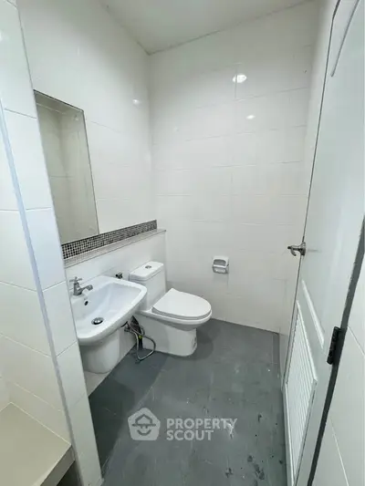 Modern bathroom with sleek white tiles and contemporary fixtures