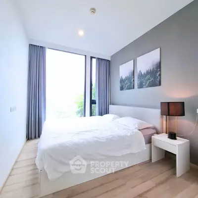 Modern bedroom with large windows and stylish decor