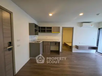 Modern open-plan living area with sleek kitchen and wooden flooring