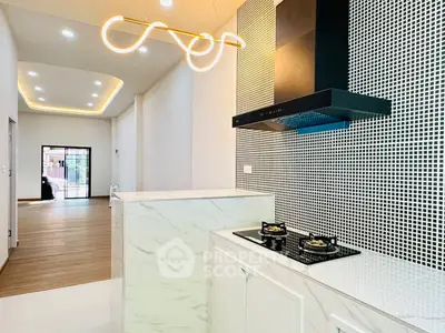 Modern kitchen with stylish lighting and gas stove in open layout