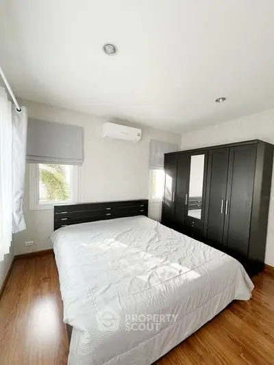 Modern bedroom with sleek furniture and natural light, perfect for a cozy retreat.