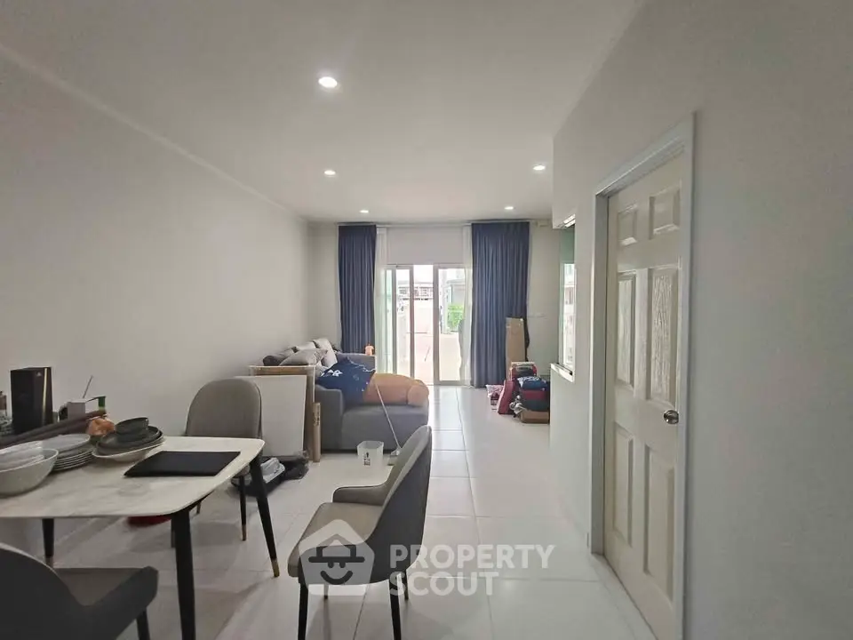 Spacious modern living room with dining area and large windows for natural light.