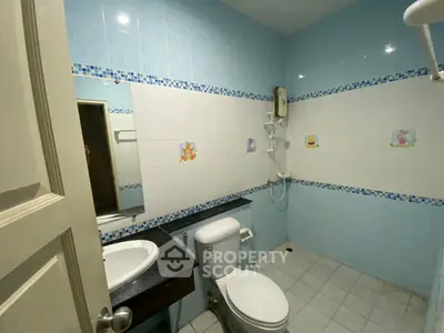 Spacious bathroom with modern fixtures and blue tile accents