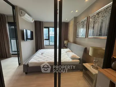 Modern bedroom with stylish decor and large windows offering city views.