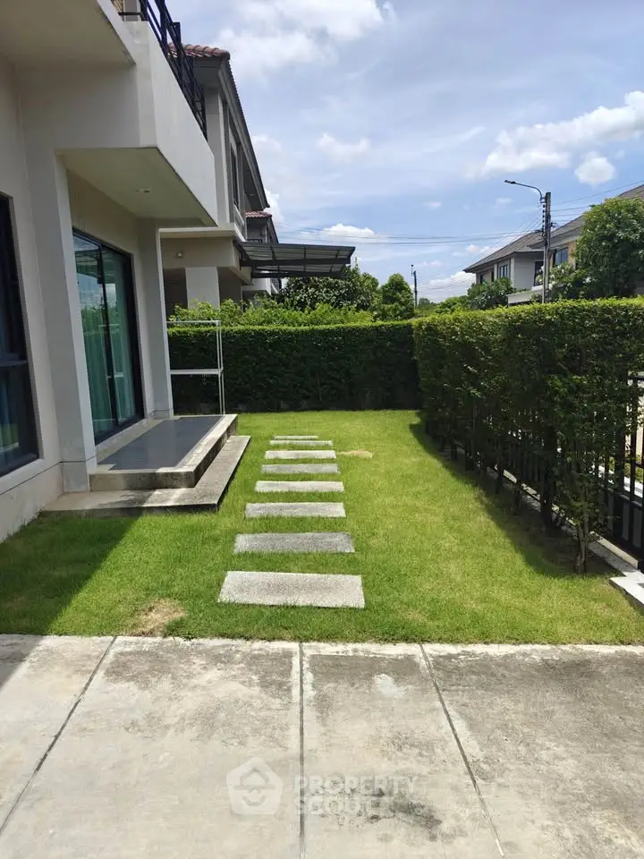 Charming suburban garden with modern pathway and lush greenery