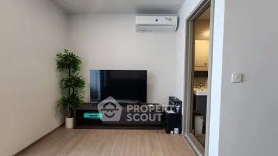 Modern living room with sleek TV setup and air conditioning unit