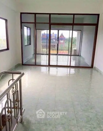 Spacious room with large windows and scenic view, perfect for natural light lovers.