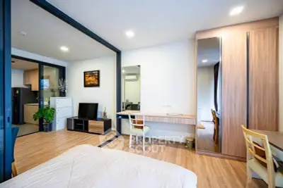 Modern open-plan bedroom with stylish decor and wooden flooring