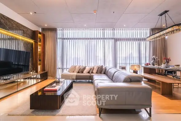 Luxurious modern living room with elegant decor and large windows.