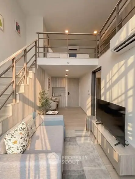 Modern loft apartment with mezzanine, stylish living area, and natural light.