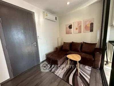 Modern living room with brown sofa, abstract art, and sleek wooden flooring