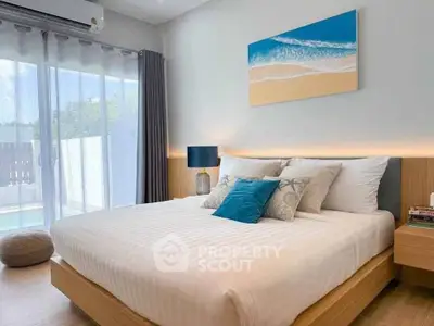 Modern bedroom with stylish decor and natural light from large window.