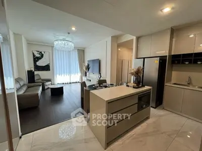 Luxurious open-plan living room and kitchen with modern decor and elegant lighting