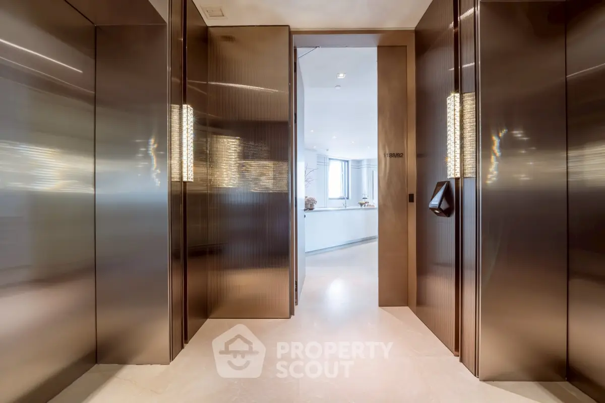 Luxurious elevator entrance leading to a modern, bright interior space with sleek design.
