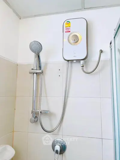 Modern bathroom with sleek shower and water heater installation.