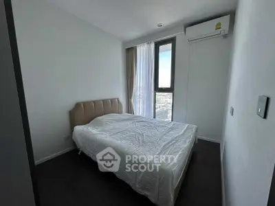 Modern bedroom with large window and air conditioning in a high-rise apartment.