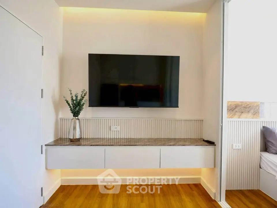 Modern living room with sleek TV setup and elegant wooden flooring