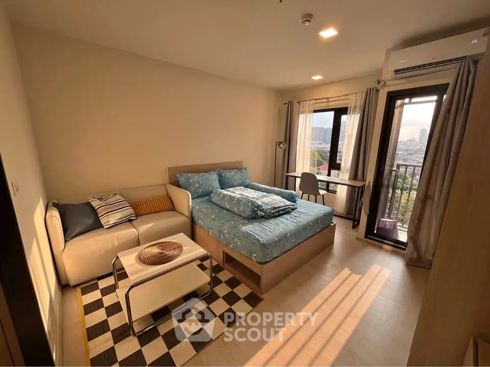Cozy bedroom with balcony view, featuring a comfortable bed and stylish decor.