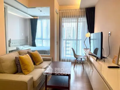 Modern living room with cozy sofa, TV, and large windows in a stylish apartment.