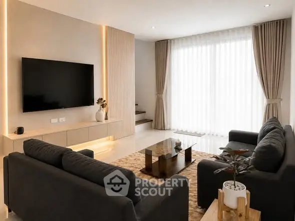 Modern living room with sleek furniture and large TV, featuring elegant lighting and floor-to-ceiling windows.