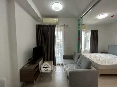 Modern studio apartment with cozy living area and natural light