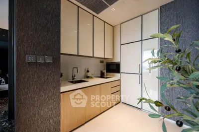 Modern kitchen with sleek cabinetry and integrated appliances in a stylish apartment.