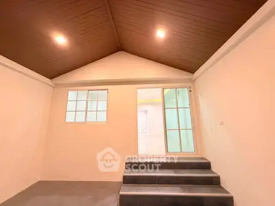 Spacious interior with high ceiling and modern lighting, perfect for versatile use.