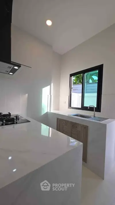 Modern kitchen with sleek marble countertops and gas stove