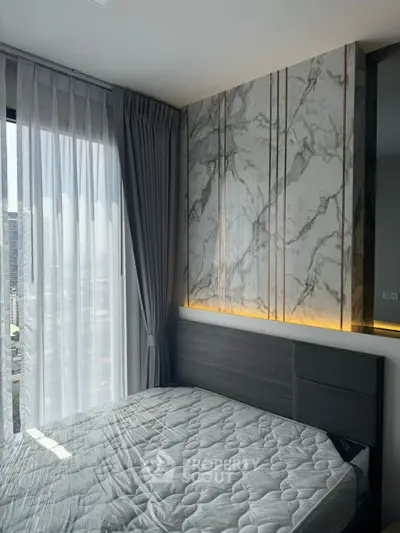 Modern bedroom with marble accent wall and large window view