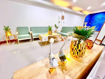 Spacious modern living room with stylish decor and vibrant lighting