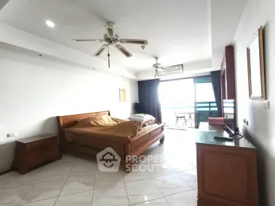 Spacious bedroom with balcony access and elegant wooden furniture