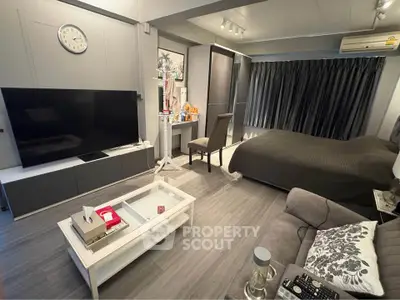 Modern studio apartment with sleek decor and large TV