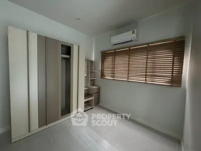 Spacious unfurnished bedroom with modern wardrobe and air conditioning.