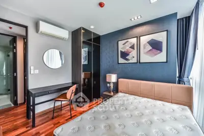 Modern bedroom with stylish decor, large window, and elegant furnishings in a contemporary apartment.