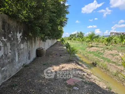 Expansive land with lush greenery and clear blue sky, perfect for agricultural development or serene retreat.