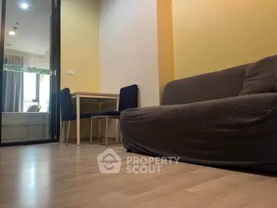 Modern living room with cozy sofa and dining area in stylish apartment