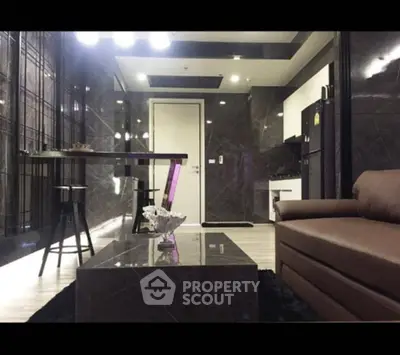Luxurious modern living room with sleek marble finishes and stylish furniture.