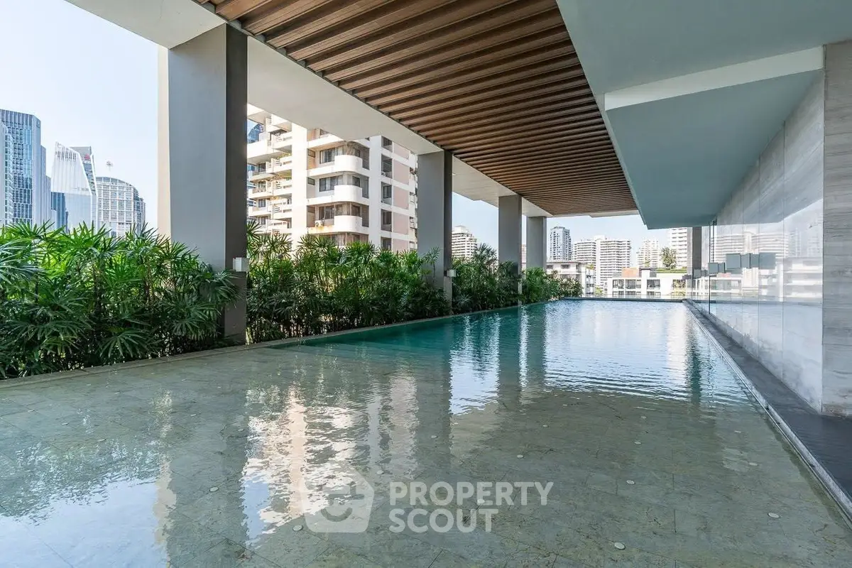 Luxurious rooftop pool with stunning city views in a modern high-rise building.